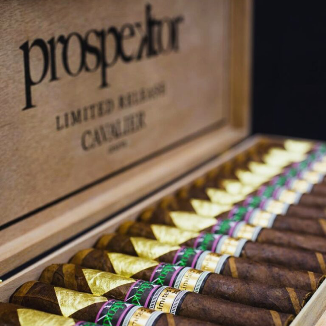 Cigars with colorful bands in a wooden 'prospectors' humidor